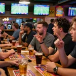 Spectators engaged in sports betting activity, watching live outcomes with excitement, soi keo nha cai strategies in action